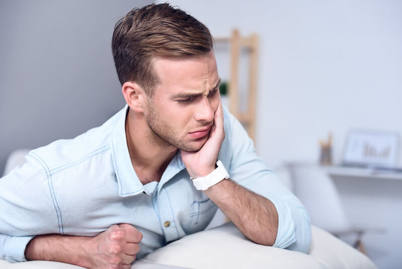 man holding face from jaw pain